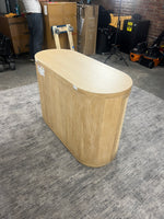Front angle of the Anthropologie Sienna entryway cabinet with woven rattan doors